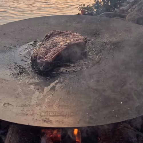 Steak on a plate, by the lake