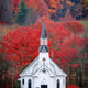 Church against the background of red leaves