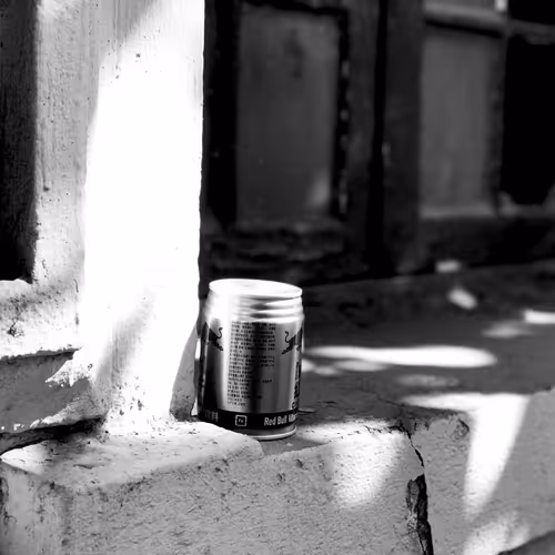 Scattered red bull cans
