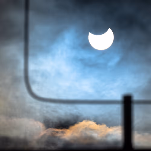 Solar eclipse over the roofs