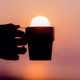 Sun rising out of a cup - old