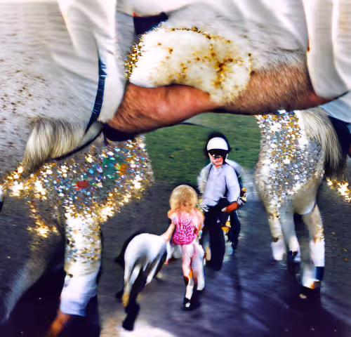 Riding my white pony Joe around the paddock with my dad leading me.