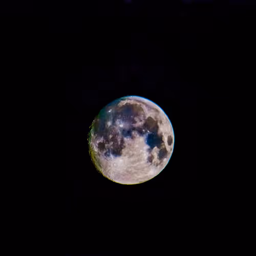 Lunar Dreamscape: A Colored Moon in the Night Sky.