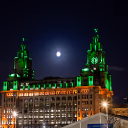 The Royal Liver Building in Liverpool shines different colours throughout the night