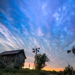 Nature across the spectrum #1. Blue #1 . Backlit blue mammatus clouds over cow shed