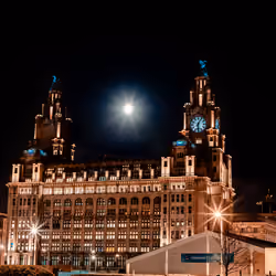 The Royal Liver Building in Liverpool shines different colours throughout the night