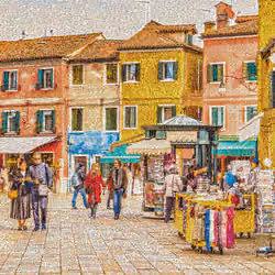 tourists in square of Burano Island in Italy