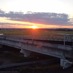 Collaboration of rural landscape, elevated railway, and sunset in Japan