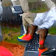 Black man in wisconsin wearing nice shoes typing words on coumputer on Mars in the rain gan 9 no sea