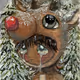 Little boy wearing a Rudolph hat in the pine forest