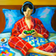 Woman Playing Playstation in bed