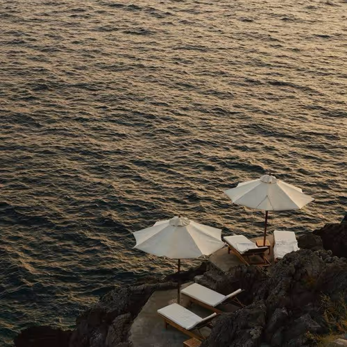 sun loungers by the cliff