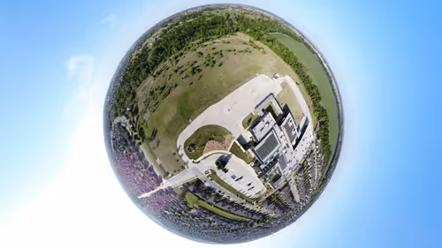Asteroid and tiny planet of a school which neighbors a WIDE open field to the side and behind....