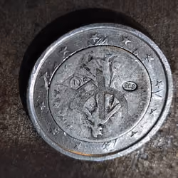 50 cent silver coin clipped into a 2 euro crown