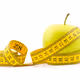Green apple with measuring tape