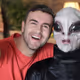Excited man taking a selfie with an Alien
