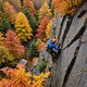 Rock climbing in autumn leaves